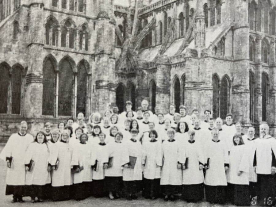 Choir standing in a group in front of a cathedral