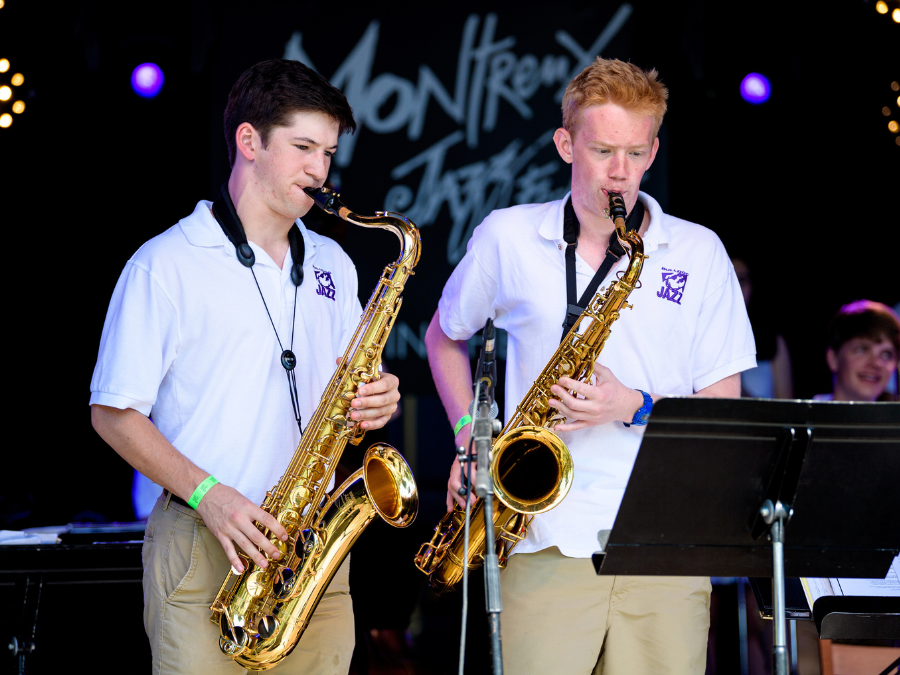 Two teenage boys playing saxophone at the Montreux Jazz Festival in Switzerland