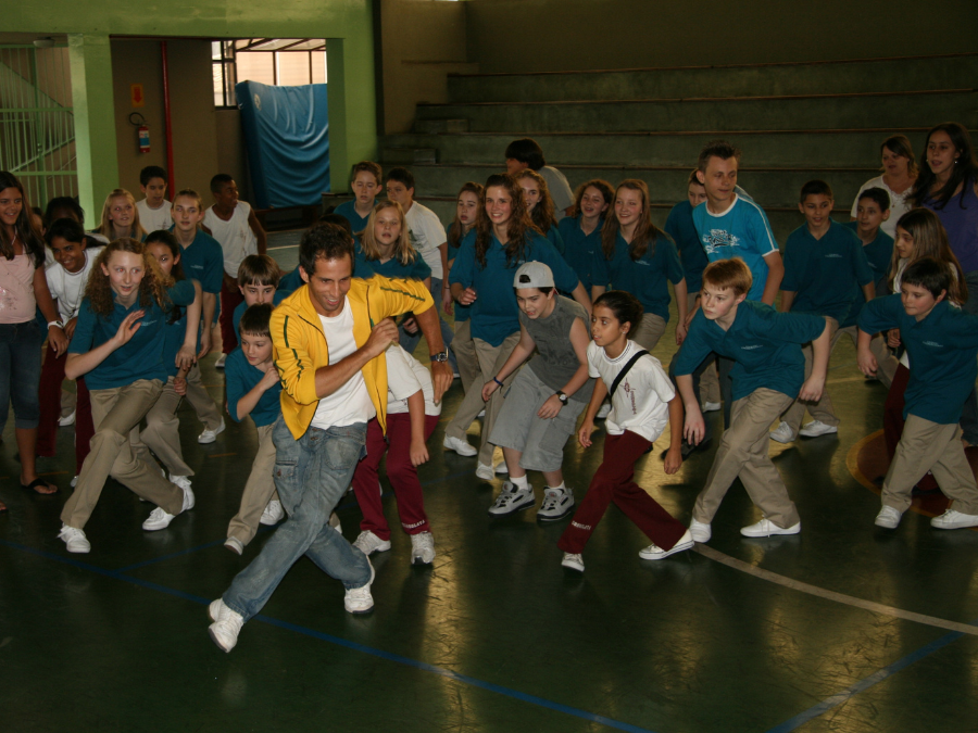 A dancer teaching a routine to a group of students